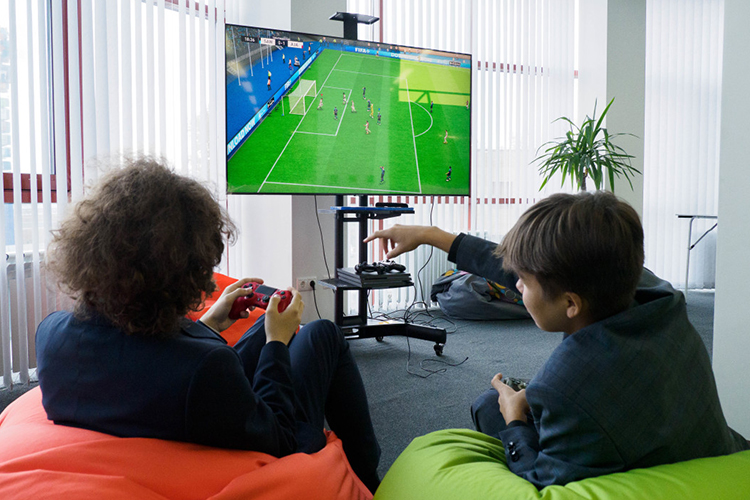 Пока ребят больше привлекла FIFA на Playstation, которая установлена в небольшой зоне отдыха